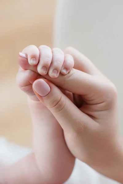 Дитина тримає палець матері — стокове фото