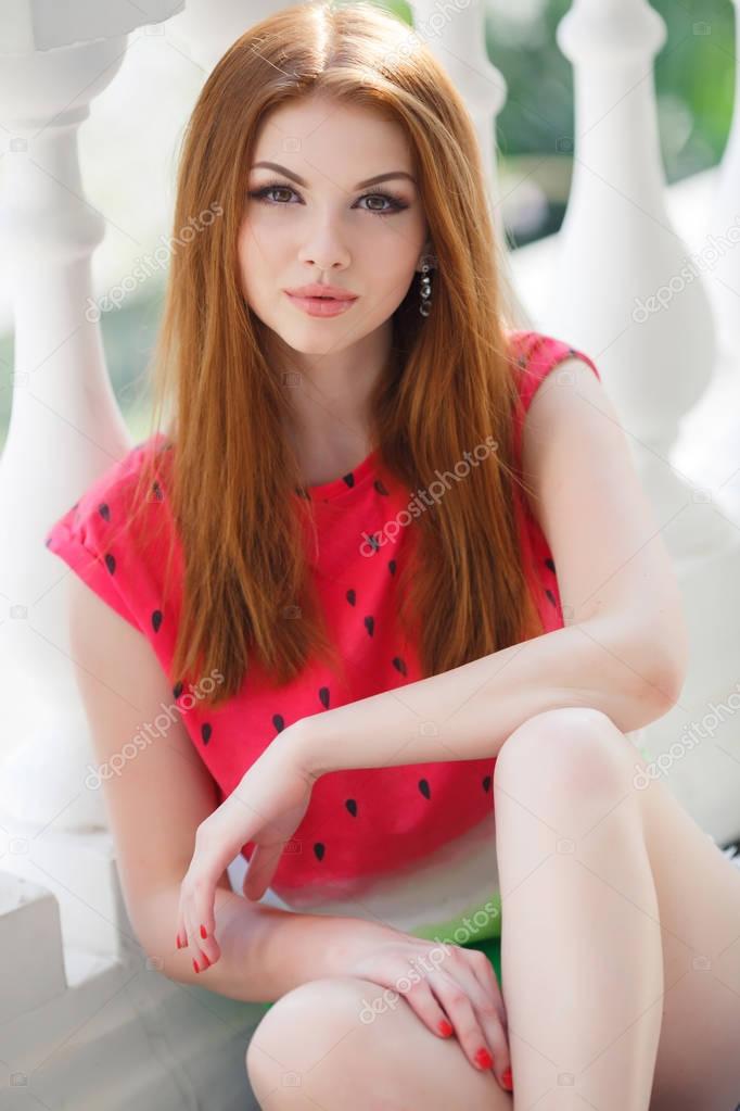 Portrait of beautiful young girl with gorgeous red hair