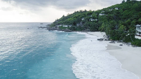 Aerial view of beautiful island at Seychelles in the Indian Ocean. Top view from drone. Spectacular aerial view of some yachts and small boats floating on a clear and turquoise sea, Seychelles in the Indian Ocean. Top view from drone