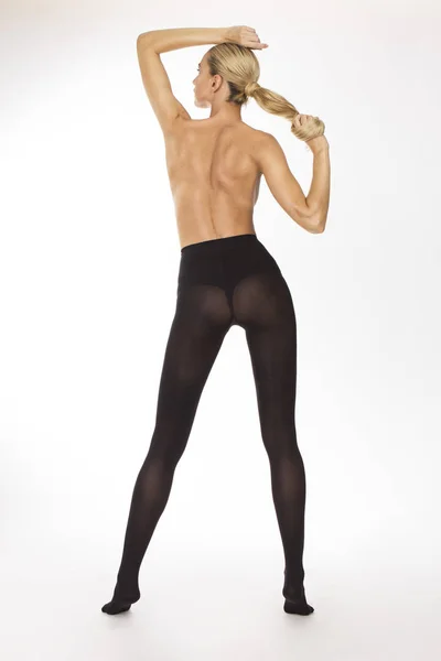 Girl in black stockings holding her hair — Stock Photo, Image
