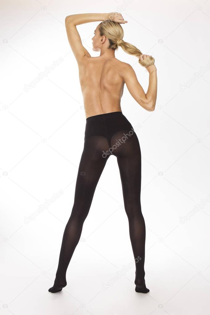 Girl in black stockings holding her hair