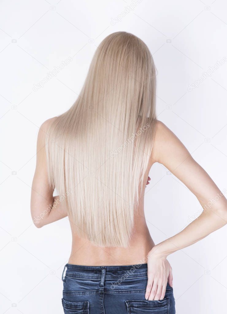 Sexy shot from the back. Girl with perfect blonde hair posing in