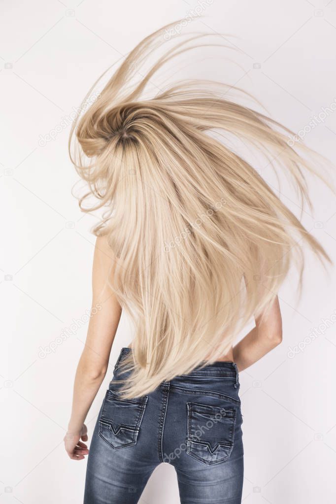 Beautifuly flying long platinum blonde hair. Anonymous look from the back.