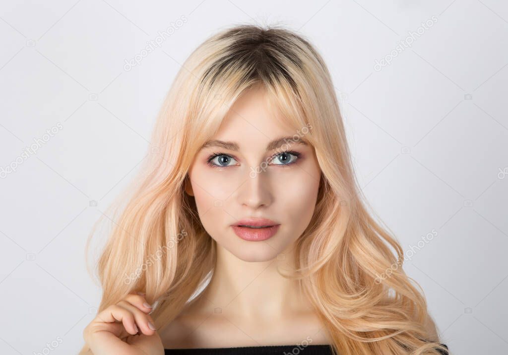 Close up portrait of a beautiful blonde girl with nice face, full lips and blue eyes.