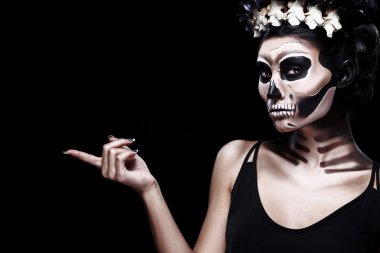 Woman in Halloween style. Frida Kahlo concept with copy spcae. Skeleton or skull makeup. clipart