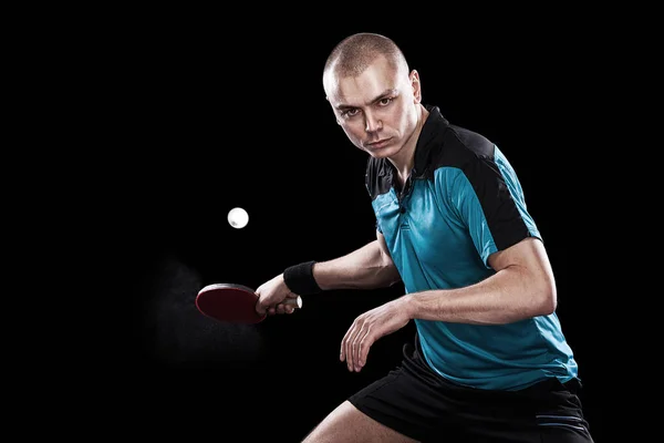 Young sports man tennis-player in play on black background. Action shot. — Stock Photo, Image