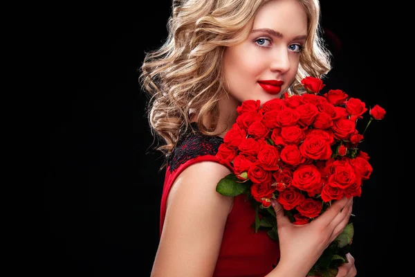 Beautiful blonde woman holding bouquet of red roses. Saint Valentine and International Womens Day, Eight March celebration. Copy space. — Stock Photo, Image