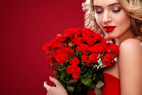 Beautiful blonde woman holding bouquet of red roses. Saint Valentine and International Womens Day, Eight March celebration. — Stock Photo, Image