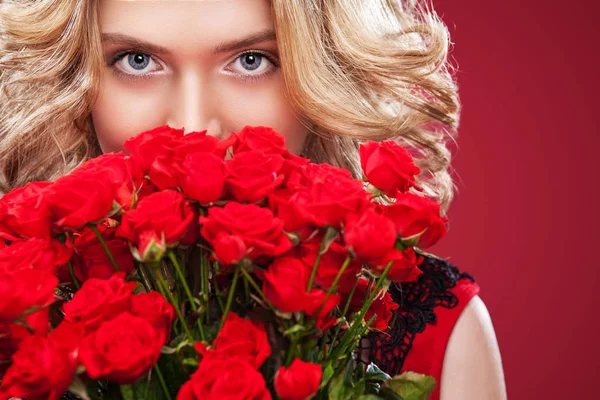 Beautiful blonde woman holding bouquet of red roses. Saint Valentine and International Womens Day, Eight March celebration. — Stock Photo, Image