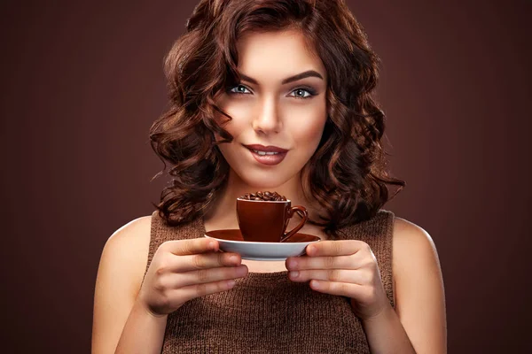 Bella giovane donna con una tazza di caffè sullo sfondo scuro — Foto Stock