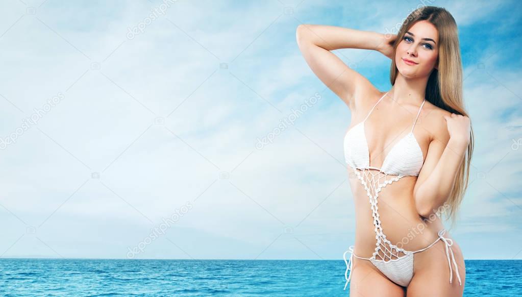 Beautiful woman in sexy bikini over sea background