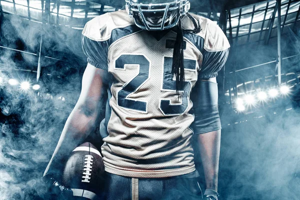 American football sportsman player on stadium with lights on background — Stock Photo, Image