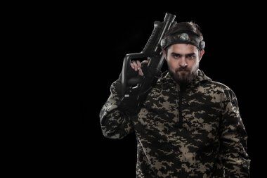 Siyah arka plan üzerine izole ağır silahlı maskeli paintball asker. Reklam kavramı.