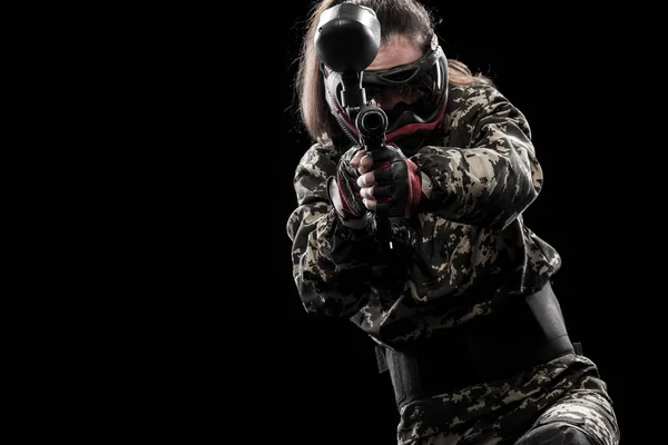 Heavily armed masked paintball soldier isolated on black background. Ad concept. — Stock Photo, Image