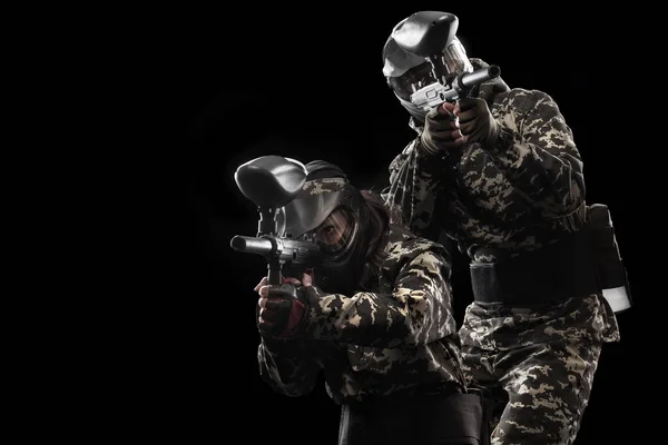 Heavily armed masked paintball soldier isolated on black background. Ad concept. — Stock Photo, Image