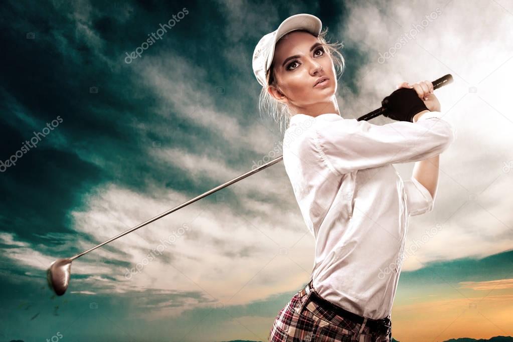 Woman golfer hitting the ball on the sky background. Copy space. Ad concept.