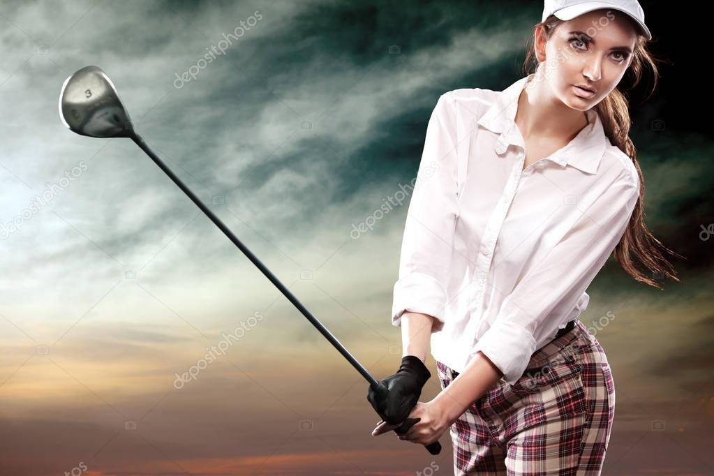 Woman golfer hitting the ball on the sky background. Copy space. Ad concept.