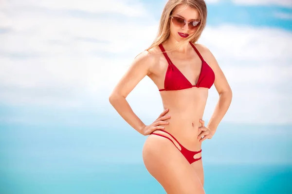 Woman in swim posing on beach over sea background at summer. — Stock Photo, Image