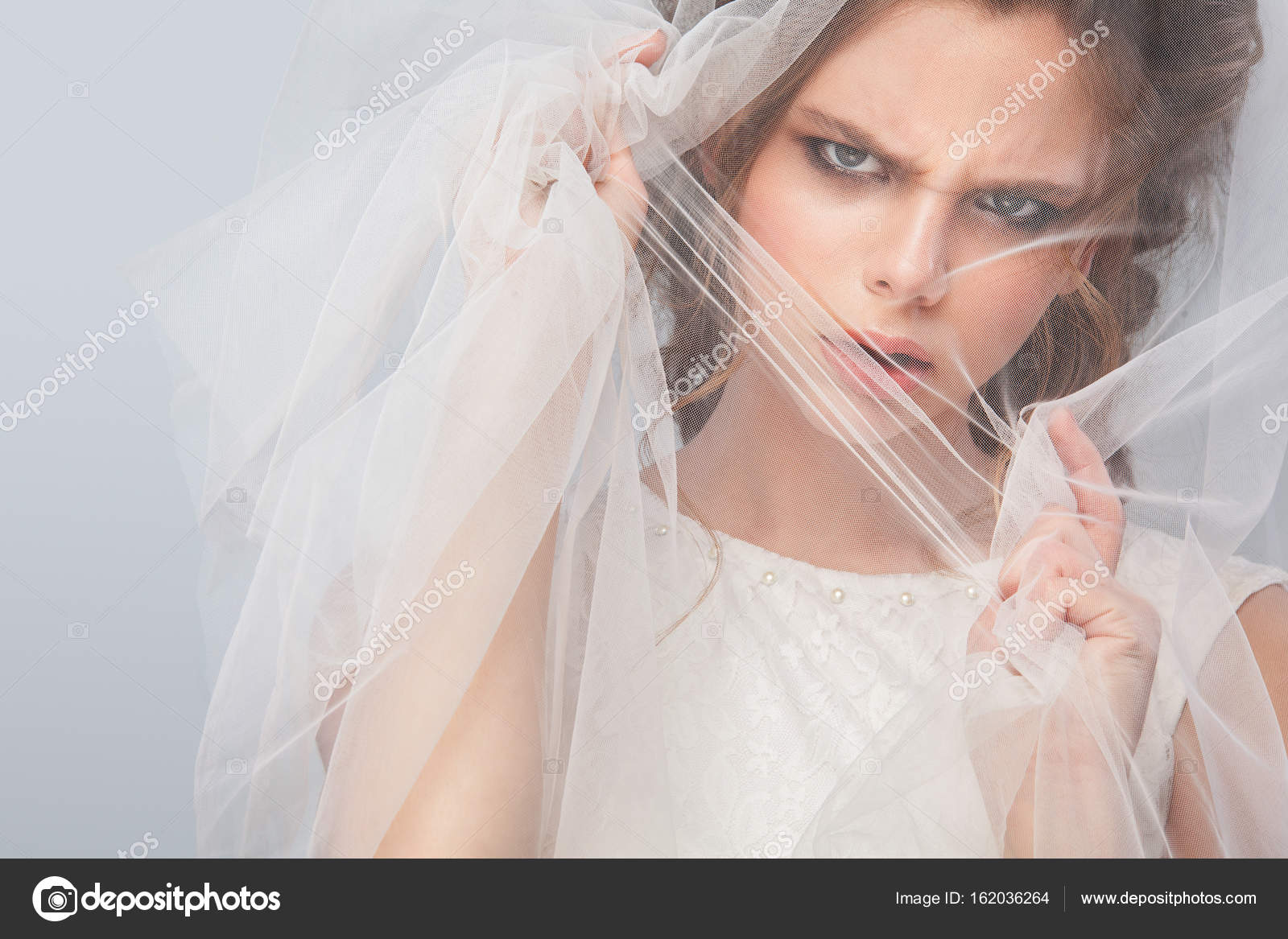 Angry Bride With Fashion Wedding Hairstyle On Gray Background