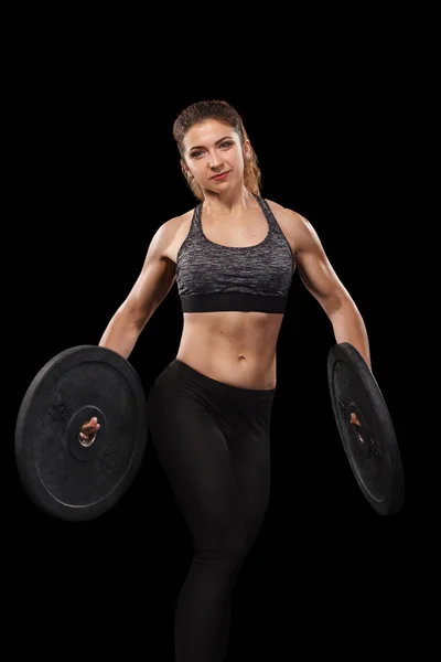 Deportiva hermosa mujer haciendo ejercicio en el fondo negro para mantenerse en forma. Fitness entrenamiento motivación . — Foto de Stock