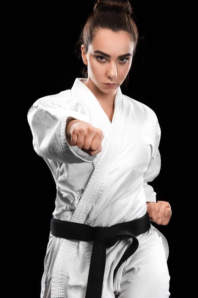 Sporty karate and taekwondo woman in white kimono with black belt on dark background. Sport concept with copy space. — Stock Photo, Image