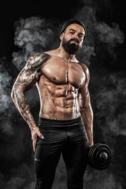 Spor salonundaki halterle spor yapan kaslı genç sporcu.