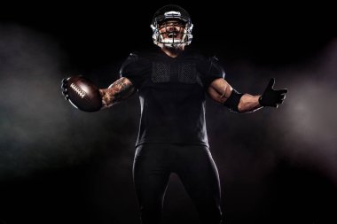 American football sportsman player isolated on black background clipart