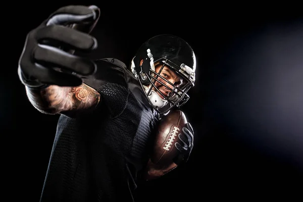 American football sportsman player isolated on black background — Stock Photo, Image