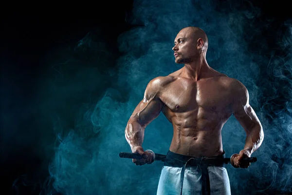 Shirtless man samurai with Japanese sword. Karate fighter on black background with smoke. Handsome and fit man sportsmen bodybuilder physique and athlete. Mens sport motivation. — ストック写真