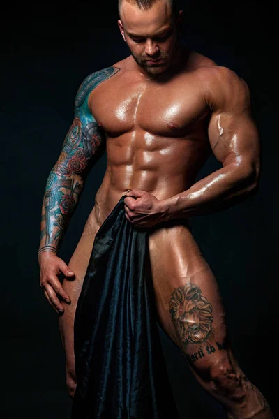 Muscular young sexy cute man bodybuilder isolated on black background. Surprised gay streptizer with naked torso. — Stock Photo, Image