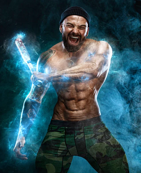 Strong and fit man bodybuilder with baseball bat shows abdominal muscles under a t-shirt. Sporty muscular guy athlete. Sport and fitness concept. Mens fashion. Energy and power. — Stock Photo, Image