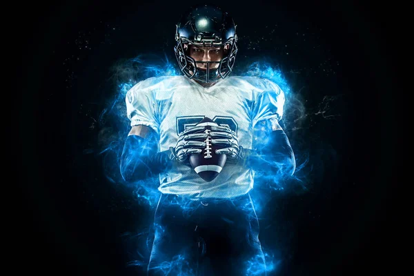 American football player in helmet with ball in hands. Fire background. Team sports. Sport wallpaper.