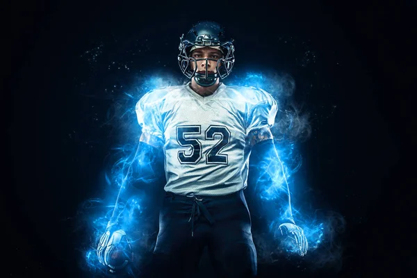 American football player in helmet with ball in hands. Fire background. Team sports. Sport wallpaper.