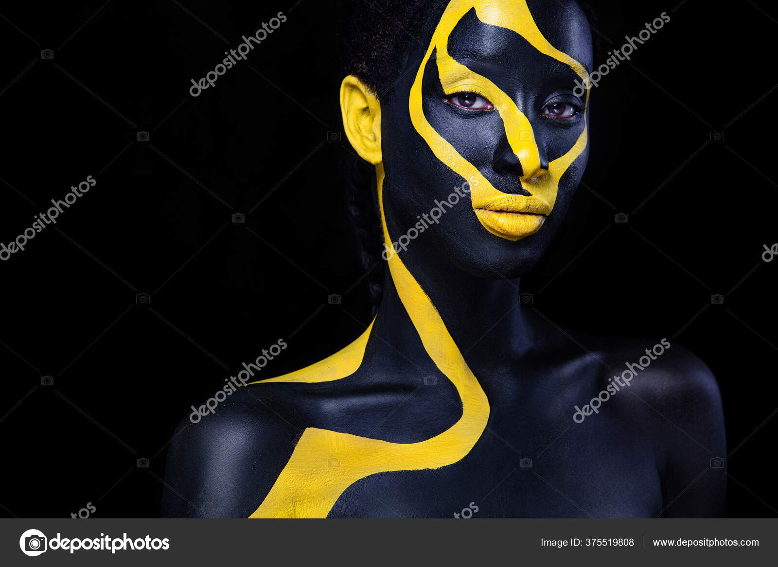 Woman with black body paint. Cheerful young african girl with art bodypaint.  An amazing model with yellow makeup. Closeup face. Stock Illustration by  ©MikeOrlov #375519808