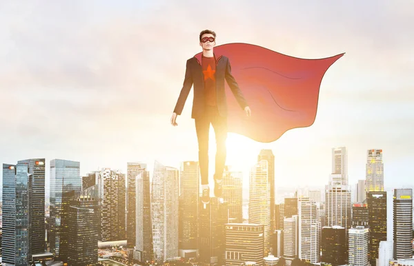 Business super hero hover over city skyline — Stock Photo, Image