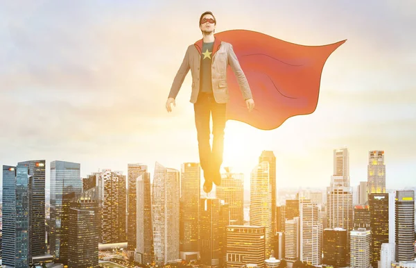 Business super hero hover over city skyline — Stock Photo, Image