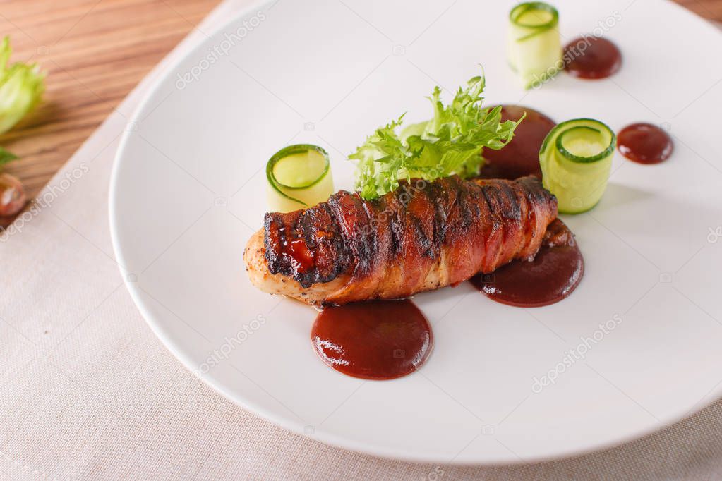Delicious meat loaf with ketchup on a white plate, macro horizontal