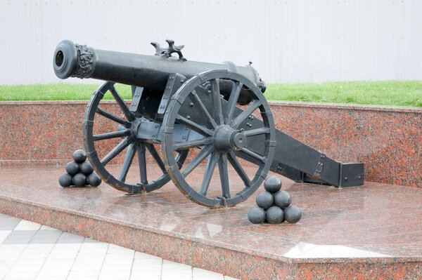 An old cannon on a granite pedestal