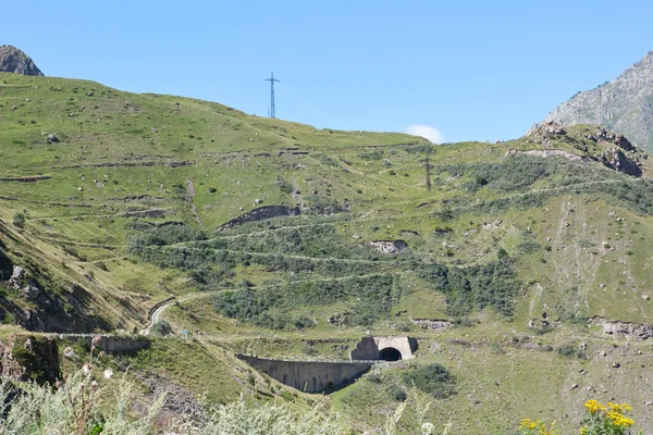 The Georgian military road at the foot of mount Kazbek. Voyenno-Gruzinskaya doroga. Main Caucasus Range — Stock Image Georgian Military Road Foot Mount Kazbek Voyenno Gruzinskaya Doroga Main Royalty Free Stock Photos