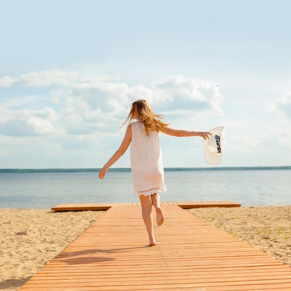 Romantic girl in white dress on pier — Stock Photo, Image