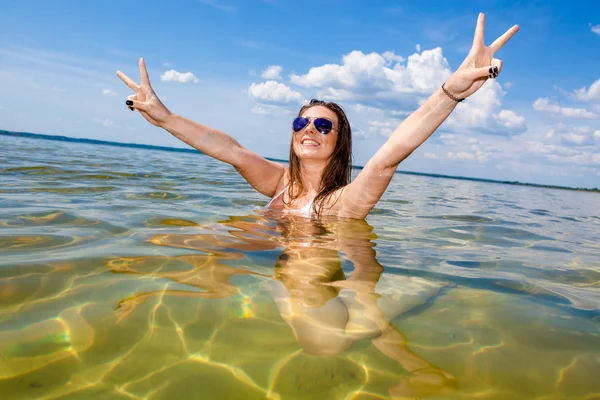 Young woman swimming in lake