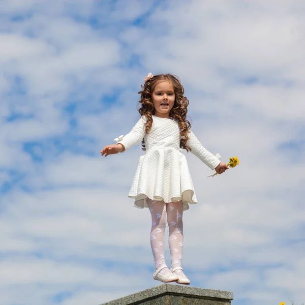 Little girl in the clouds — Stock Photo, Image