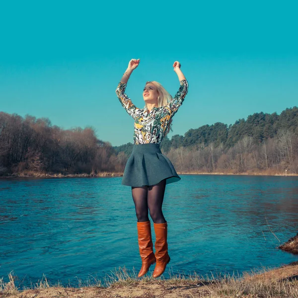 Happy Young Woman Jumping over blue sky — Stock Photo, Image