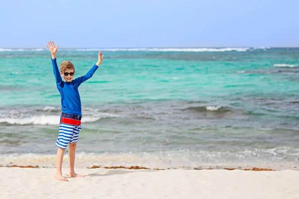 Boy in rashguard and swimwear at the beach — Stock Photo, Image