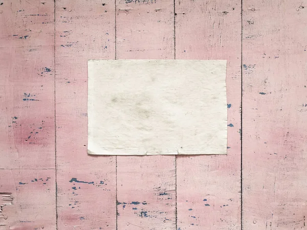 paper on pink wooden wall