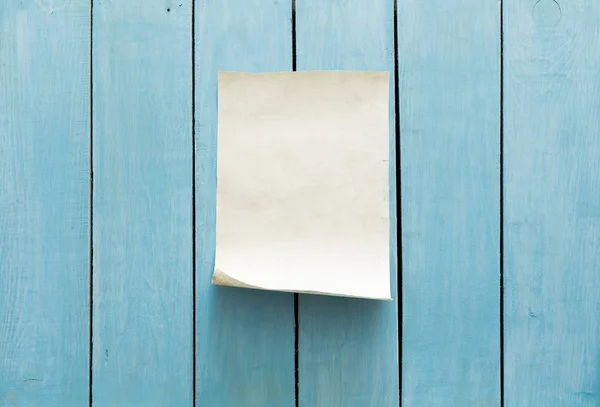 Régi papír kék falon — Stock Fotó