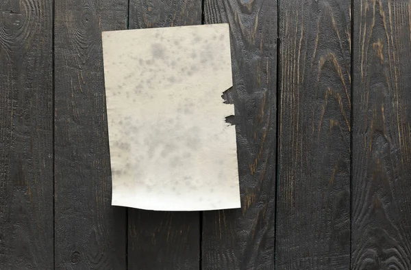 Old paper on wooden wall — Stock Photo, Image