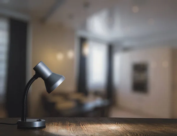 lamp on table with blurred room interior on background