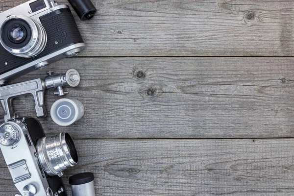 vintage still cameras on grunge wooden table