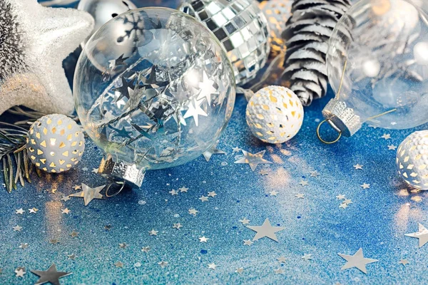 glass ball, holiday lights and silver cones for christmas tree decorations